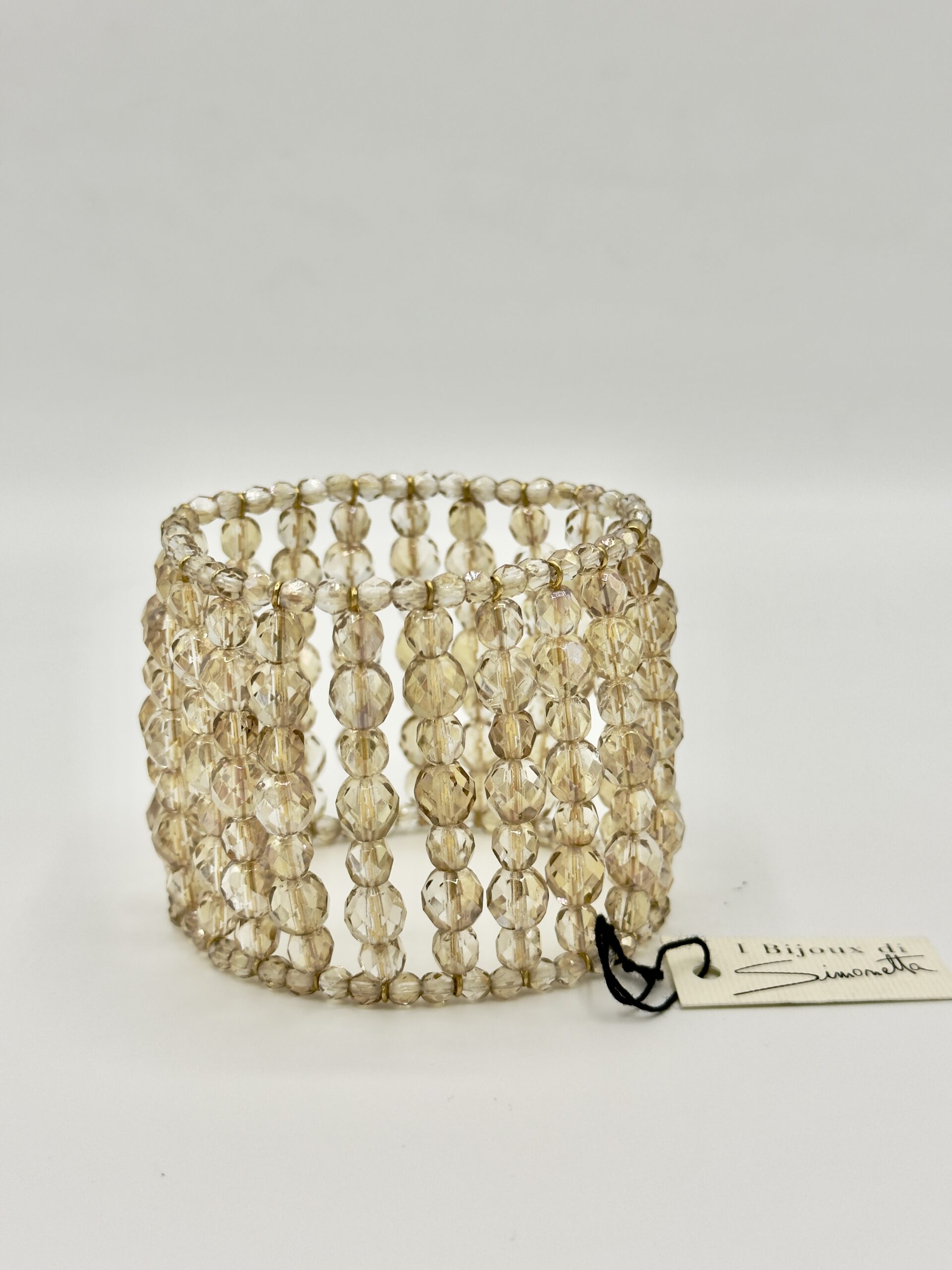 Elegante bracciale elastico con barrette di mezzi cristalli