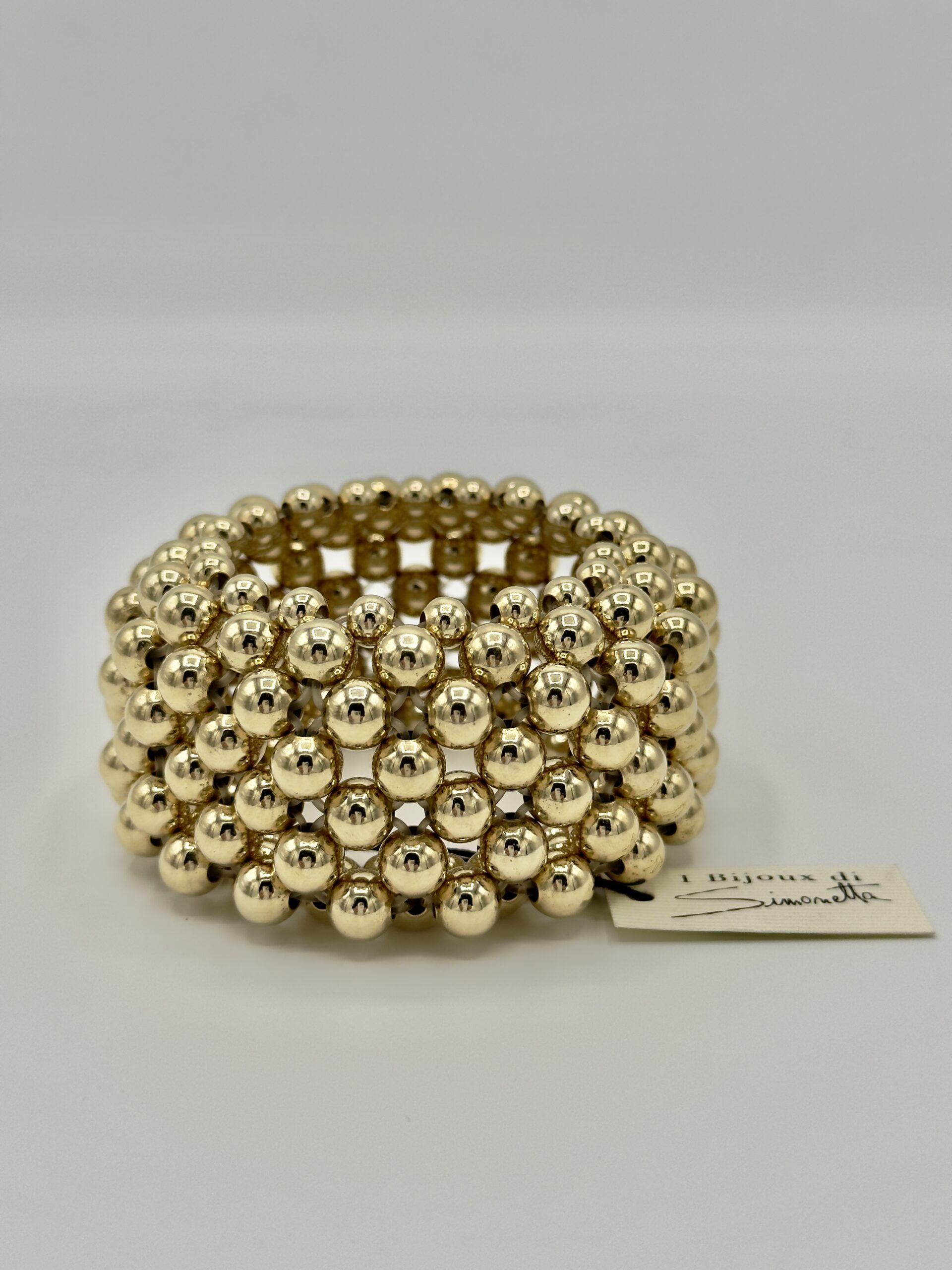 Bracciale lavorato a stuoia con sfere dorate